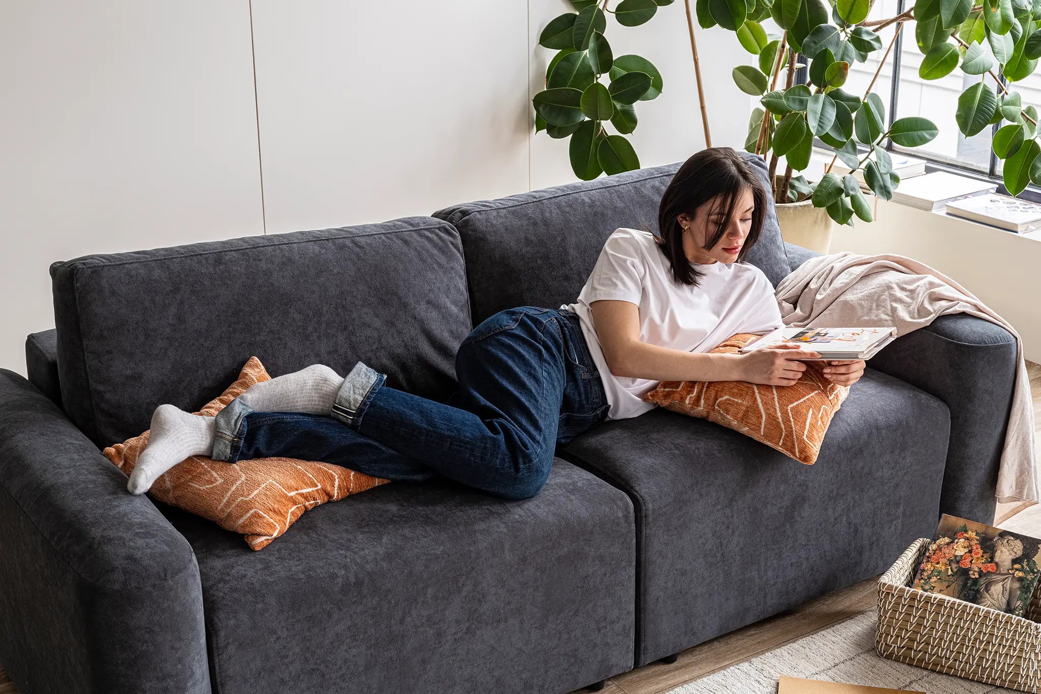 Woman sitting comfortable on a modular couch in her Canada apartment