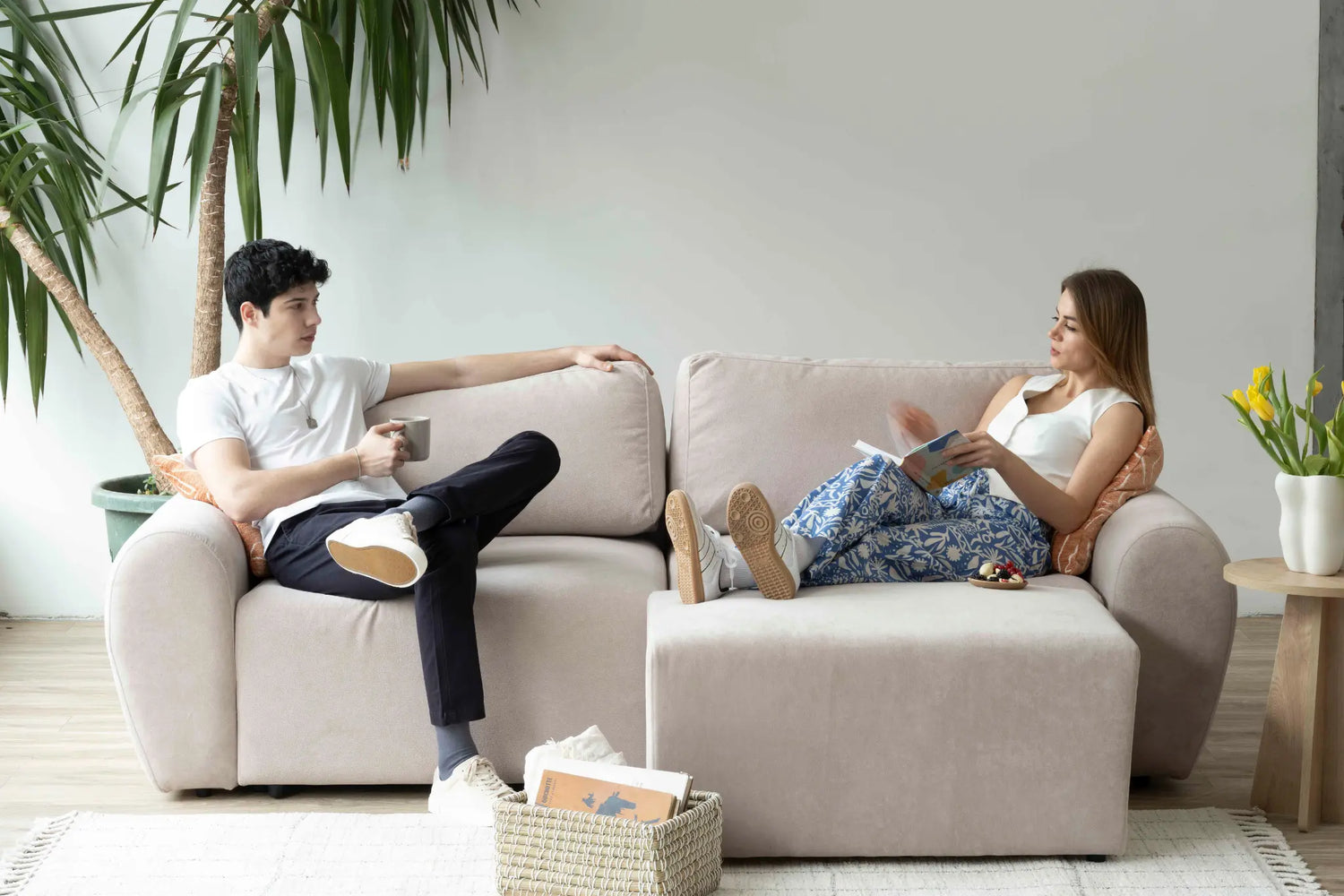 A couple sitting comfortably in a modular L shaped couch
